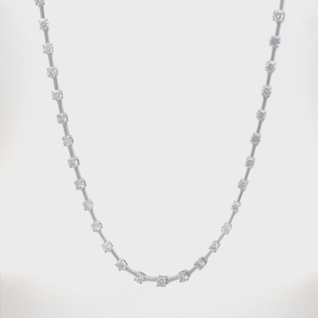 White gold necklace with a row of round diamonds on a white background.