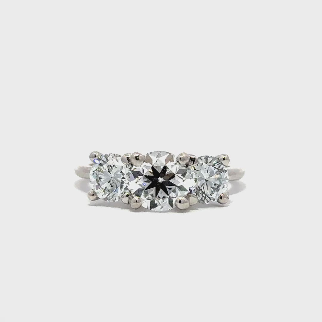 Silver three stone diamond ring in a white background