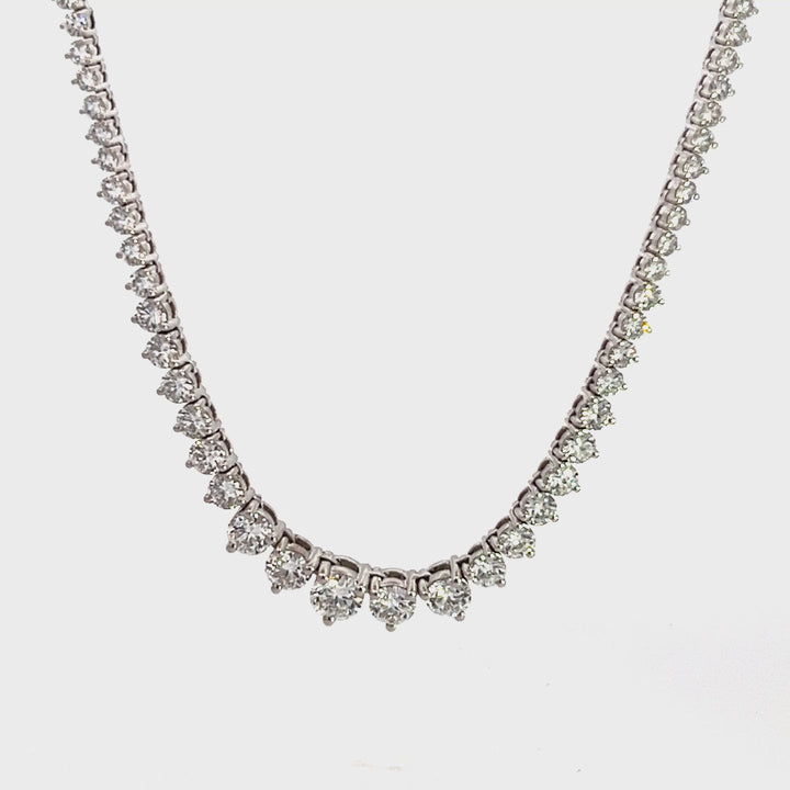 White gold diamond tennis necklace on a white background.