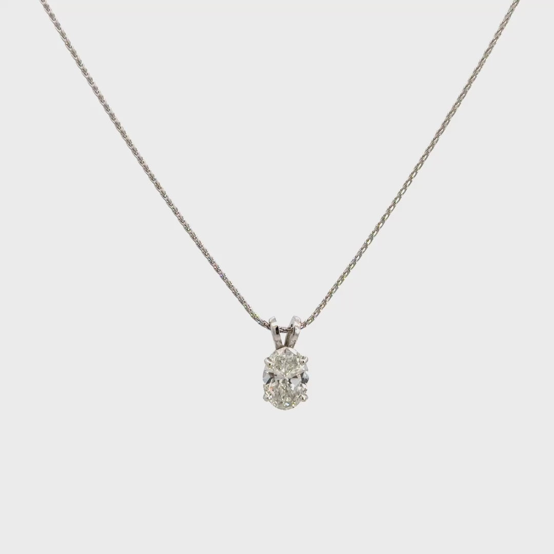 Silver necklace with a oval-cut diamond in a four-prong setting pendant on a white background.