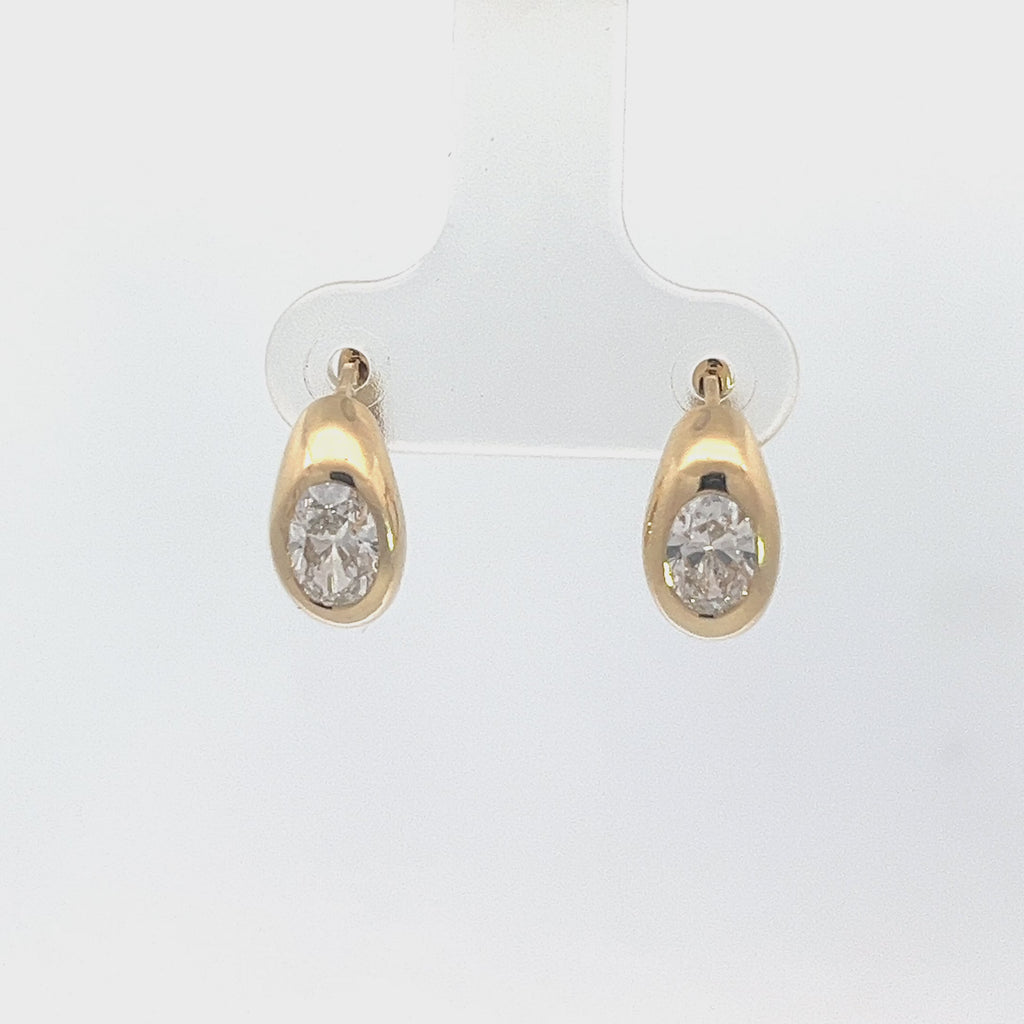 Yellow gold drop earrings with round diamonds in a pear-shaped setting, on a white background.