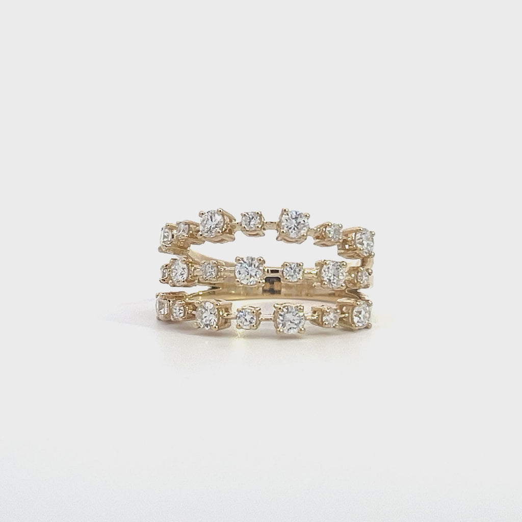 Yellow gold ring with three rows of diamonds, on a white background.