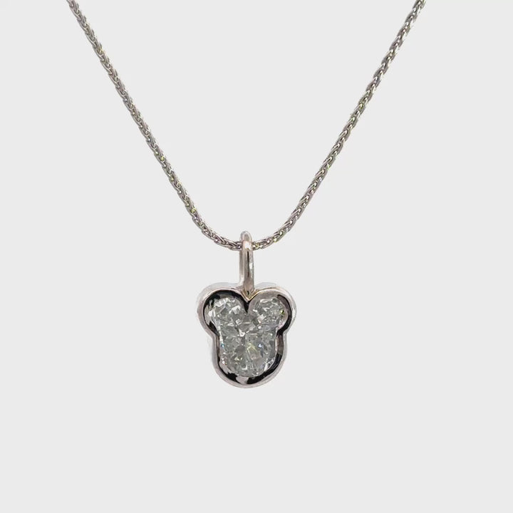 Silver necklace with a diamond pendant shaped like a Mickey Mouse head  in a bezel setting