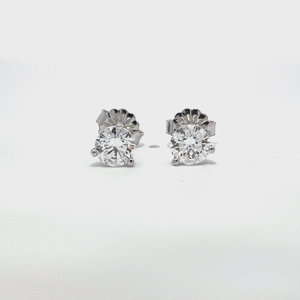 White gold stud earrings with round diamonds on a white background.