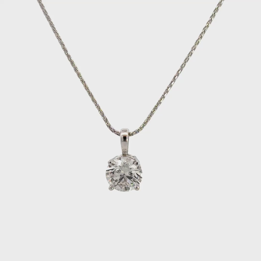 Silver necklace with diamond pendant against white background