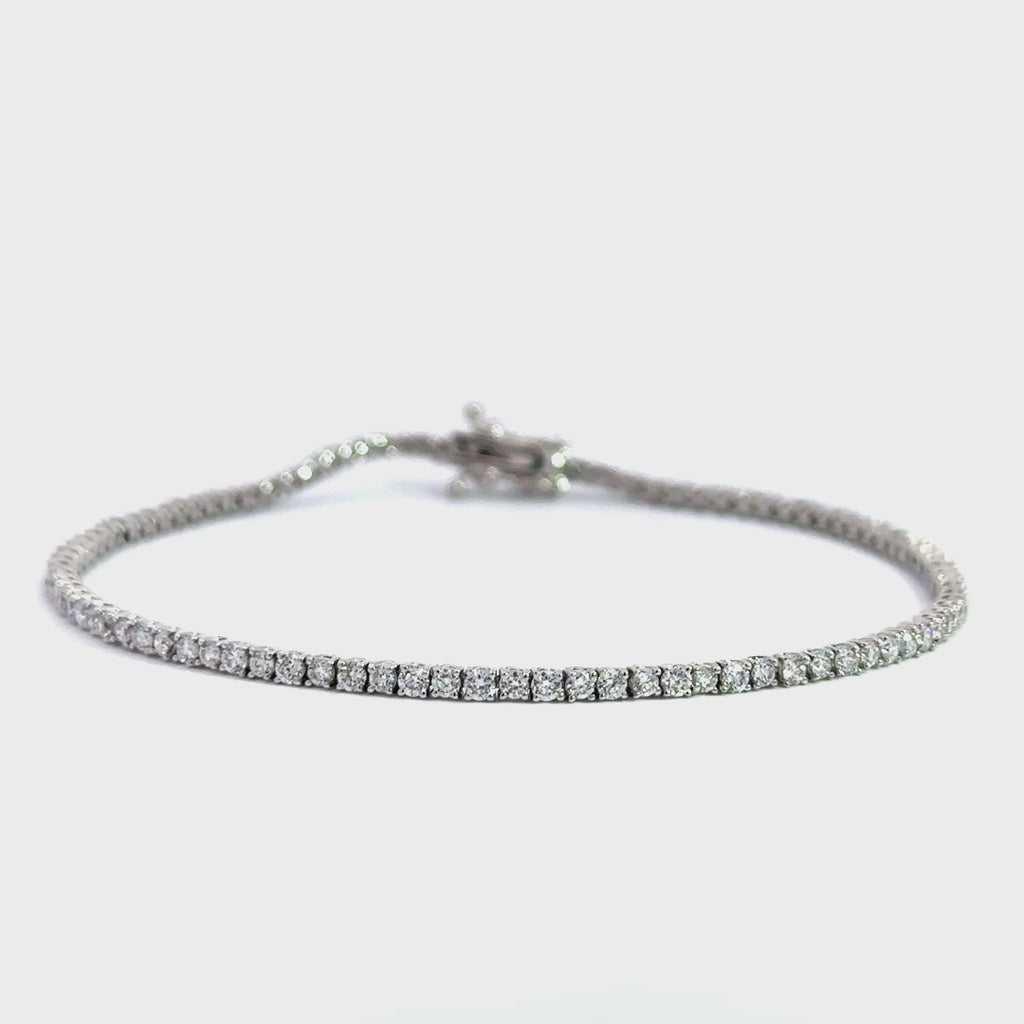 Silver diamond tennis bracelet on a white background.