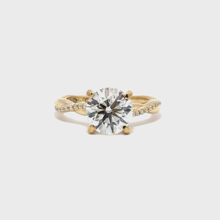 Gold engagement ring with a round-cut center diamond.