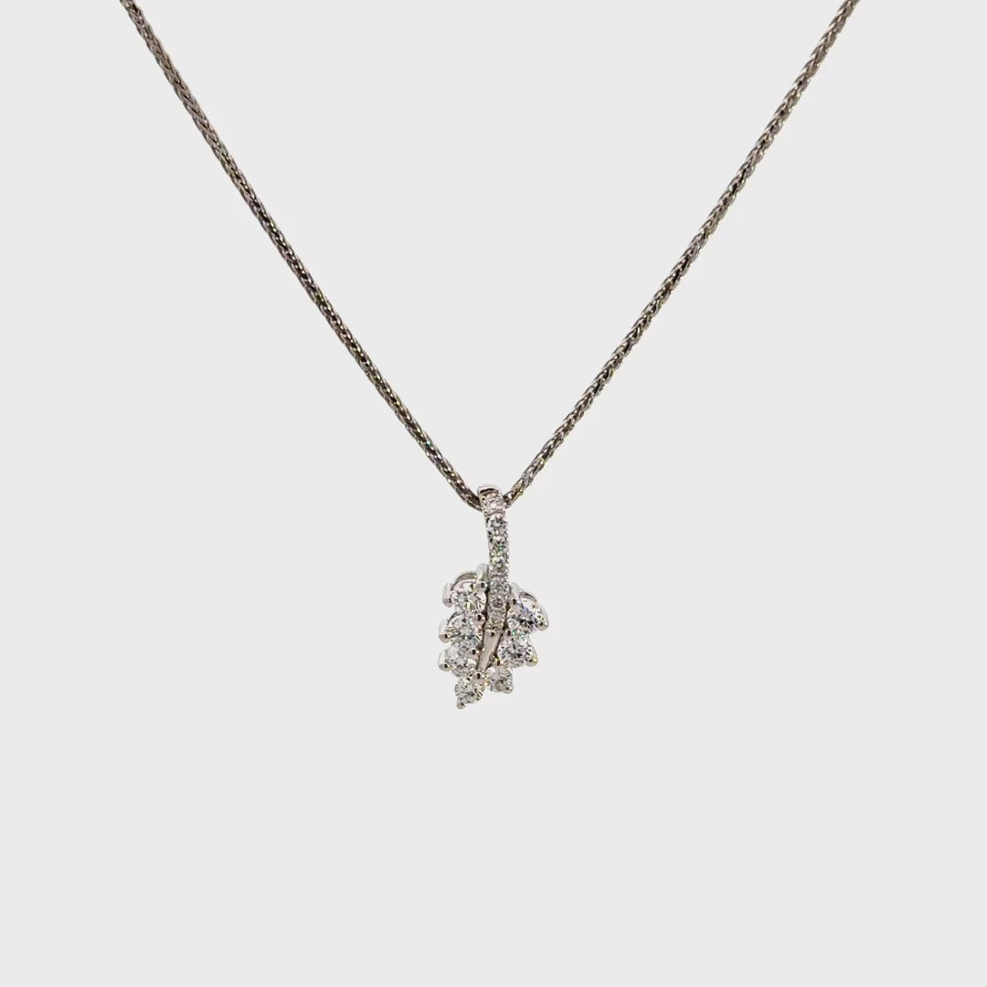 Diamond leaf pendant necklace on a white background