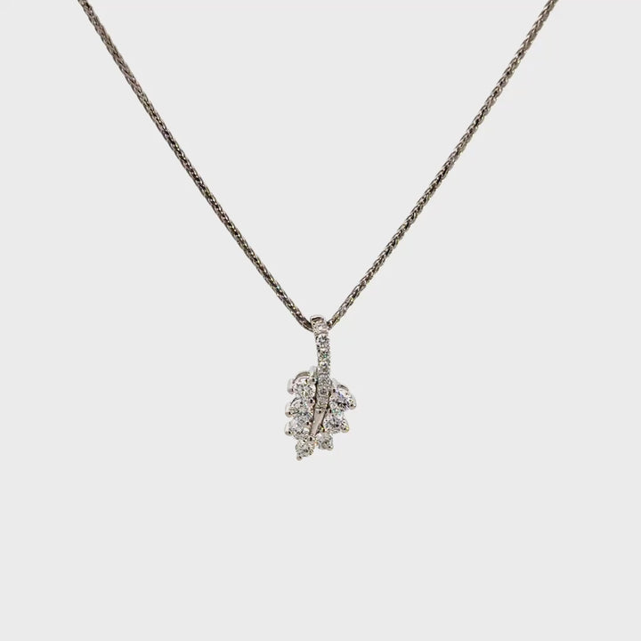 Diamond leaf pendant necklace on a white background