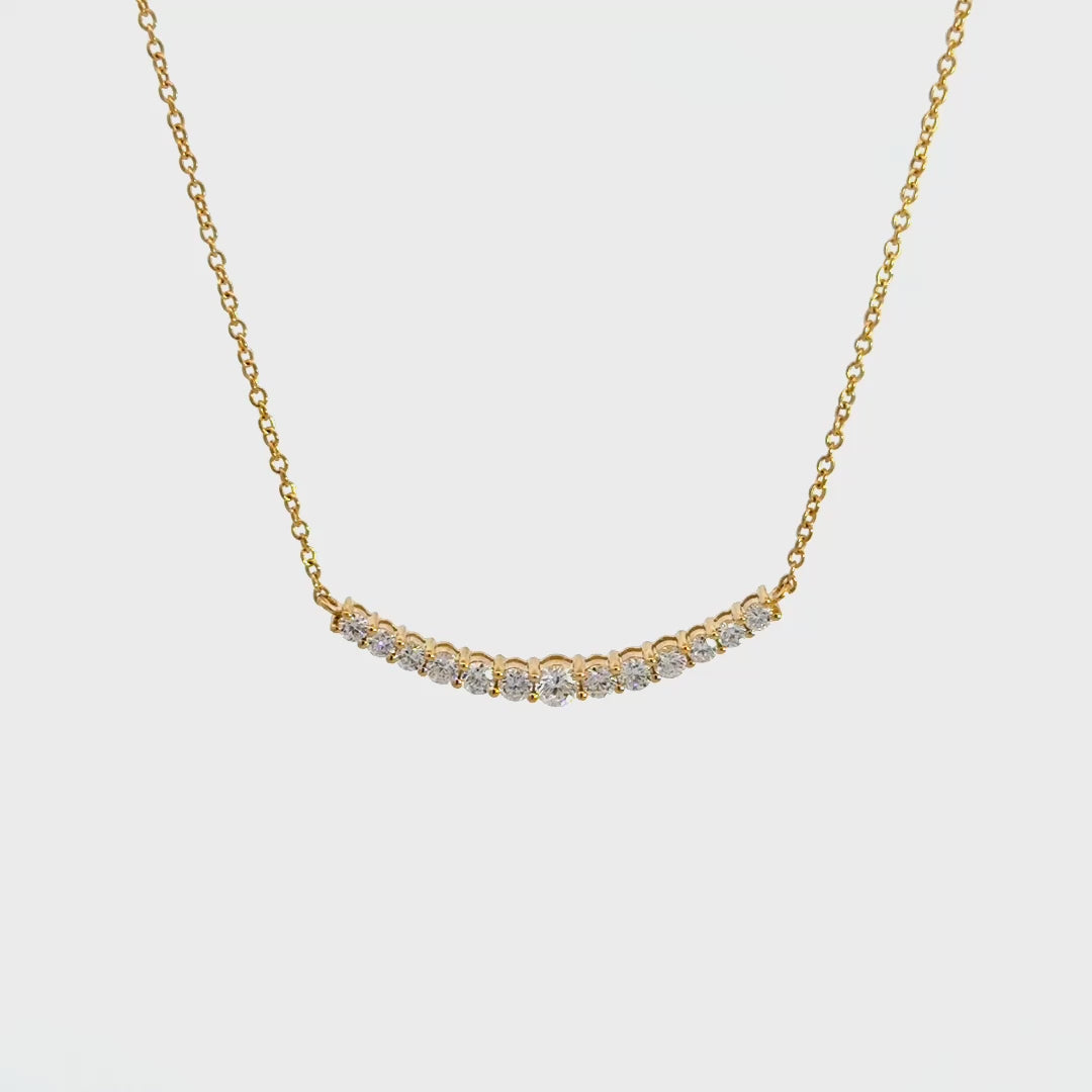 Yellow gold diamond necklace on a white background