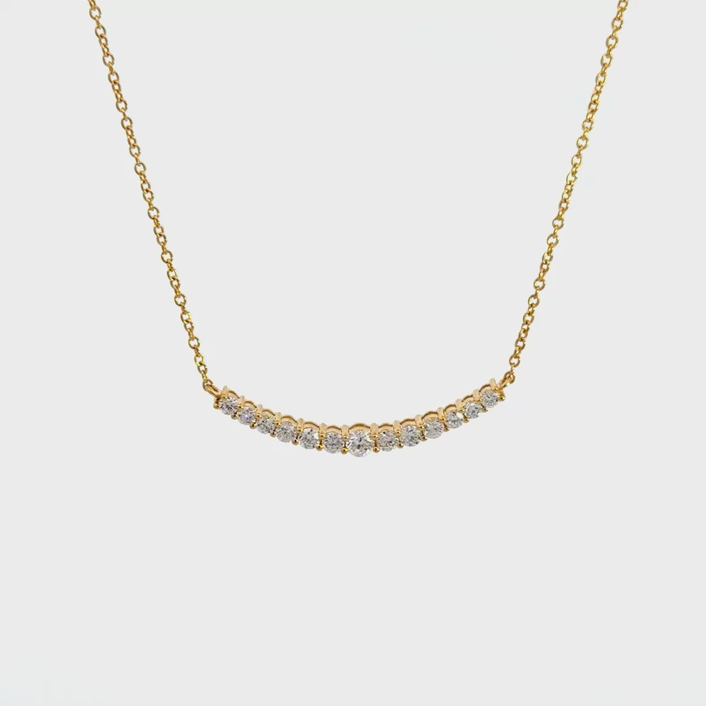 Yellow gold diamond necklace on a white background