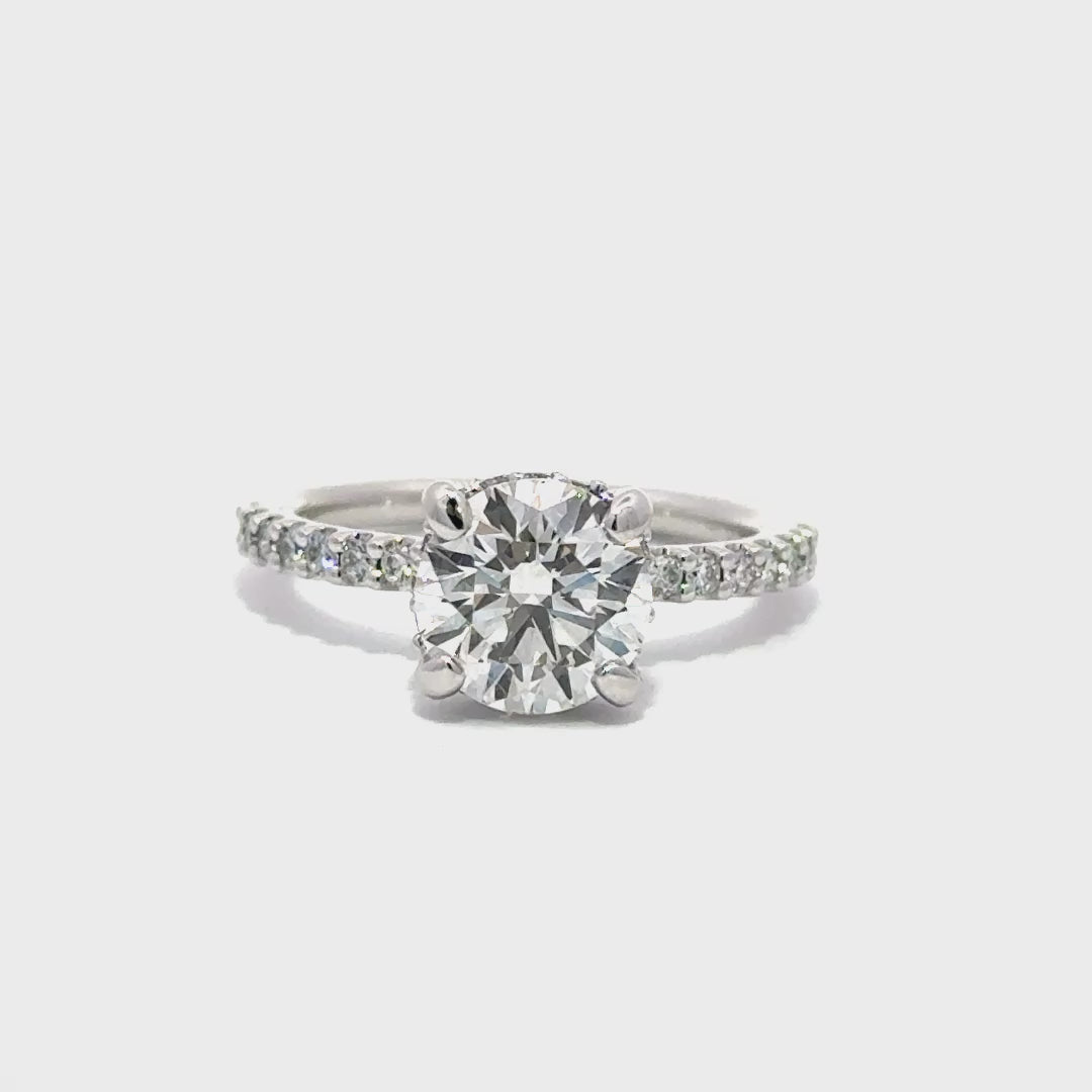 Silver engagement ring with a center round cut diamond.