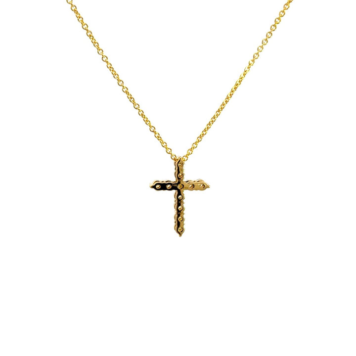 Yellow gold diamond cross necklace on a white background